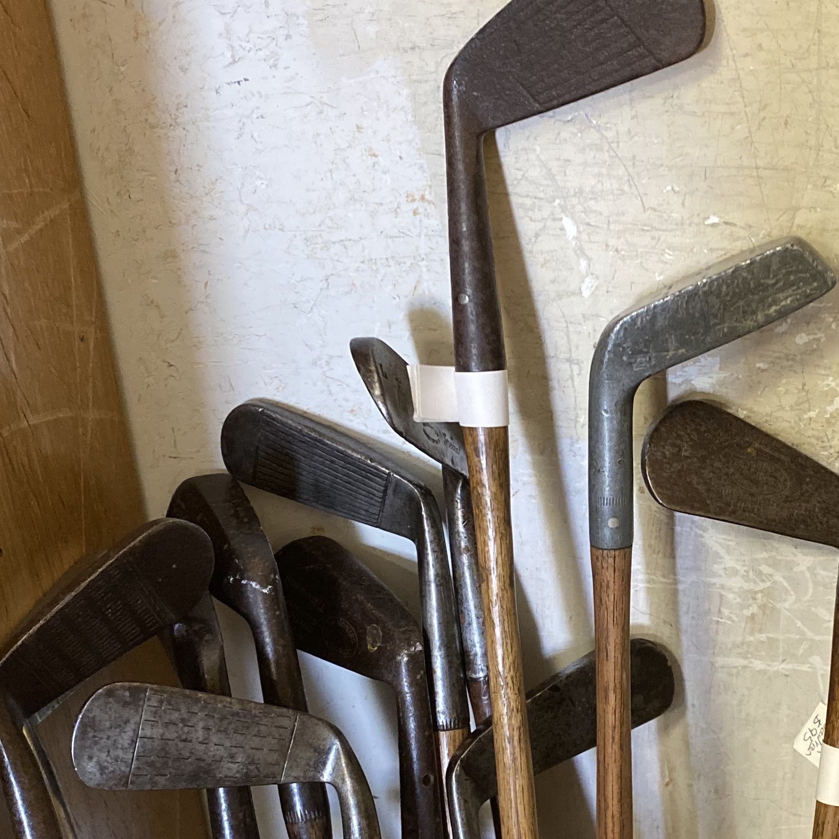 Eleven old golf clubs
